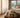 Open weekendtas met zachte badjas, slippers en toilettas op een hotelbed, met een serene spa-suite en warm ochtendlicht op de achtergrond.