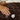 Hand resting on the soft brown SJUMO Cacao Cloud faux fur throw with OEKO-TEX and FSC labels
