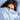 Vertical close-up of a woman wrapped in light blue organic cotton sateen bedding with GOTS, BSCI, and OEKO-TEX certification logos