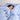 Woman relaxing with eyes closed, smiling, wrapped in light blue organic cotton sateen bedding in Light Blue