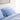 Close-up of stacked light blue organic cotton sateen pillows and duvet cover