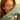 Woman resting her face on a Sage Green SJUMO Tencel Sateen pillowcase, certified by FSC, LENZING and OEKO-TEX.