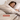 Woman sleeping under a Sand SJUMO organic cotton duvet cover, unmatched softness.