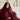 Smiling woman wrapped in a soft burgundy SJUMO Silky Smooth duvet cover