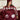 Woman in bed with the burgundy Silky Smooth duvet cover and sleep mask, OEKO-TEX and BSCI certified bedding
