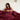 Woman sitting up in bed under a SJUMO Silky Smooth duvet cover in Burgundy