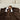 Vrouw zit in bed en knuffelt het ultrazachte SJUMO Silky Smooth dekbedovertrek in Dark Brown