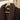 Detail van de SJUMO badjas in Cacao Brown aan een houten hanger, met zachte voering en SJUMO label